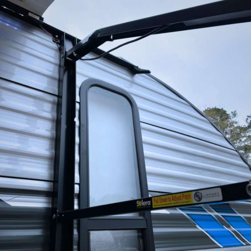 Travel Trailer With Awning Extended. Showing Broken Awning Arm To Be Fixed.